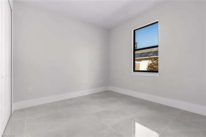 Unfurnished room with light tile patterned floors