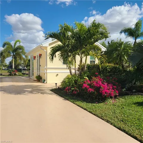 View of property exterior with stucco siding and driveway