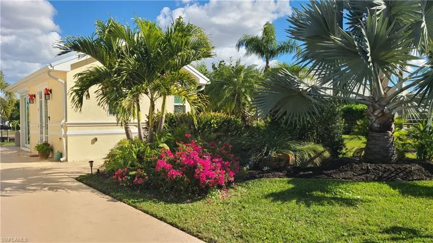 View of side of property with stucco siding and a lawn