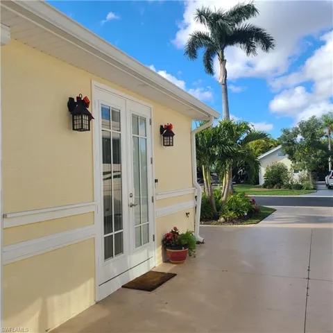 Property entrance with french doors and stucco siding