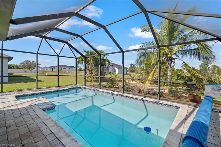 Outdoor pool with a lanai and a sunroom
