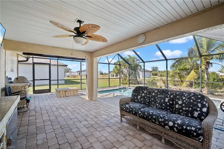 Sunroom featuring ceiling fan and a patio