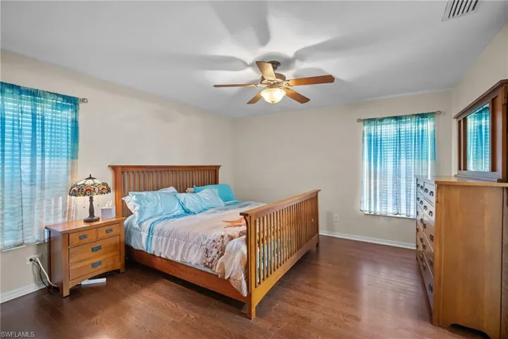 Bedroom featuring dark wood-style flooring and a ceiling fan