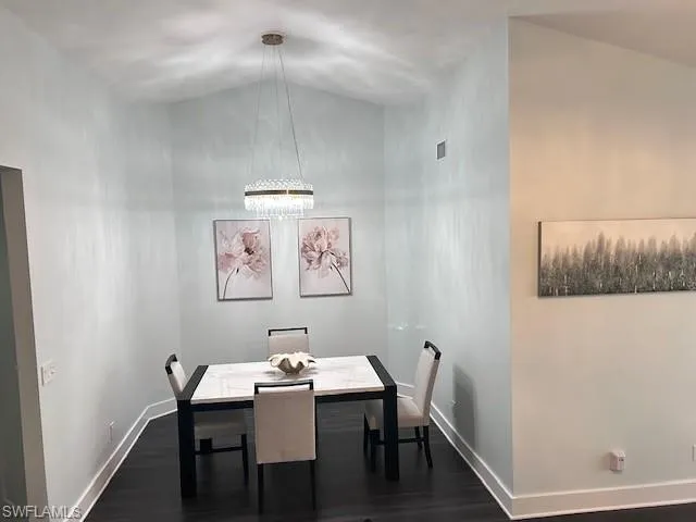 Dining room with dark wood finished floors and baseboards