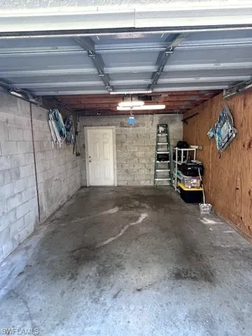 Garage featuring concrete block wall