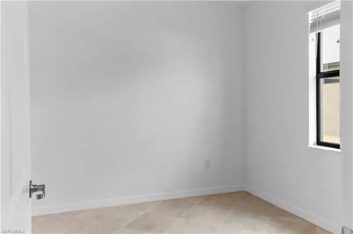 Unfurnished room featuring plenty of natural light
