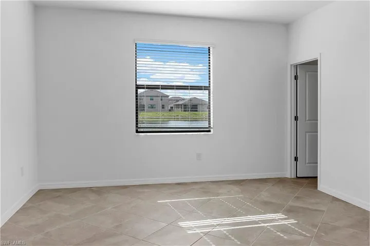 Empty room featuring baseboards