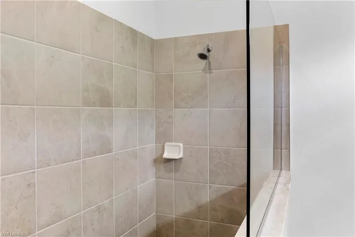 Bathroom featuring tiled shower