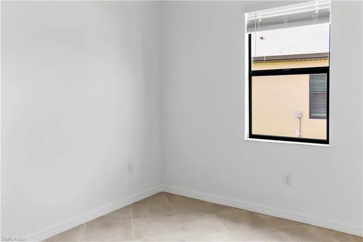 Unfurnished room featuring baseboards