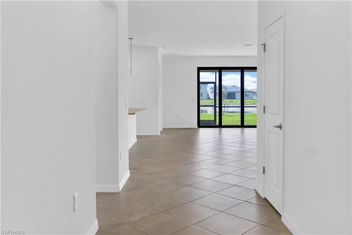 Hall with light tile patterned flooring