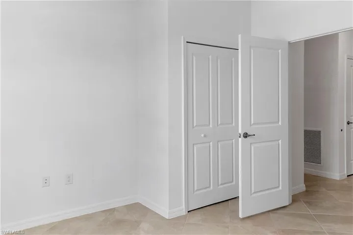 Unfurnished bedroom with light tile patterned floors and a closet
