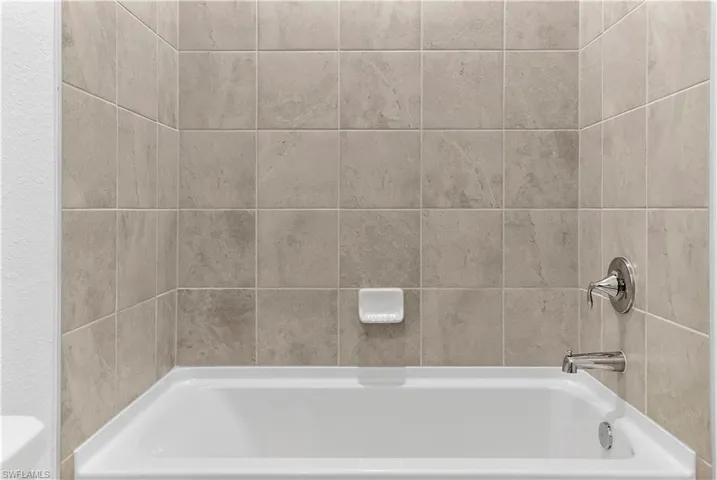 Bathroom featuring bathing tub / shower combination and toilet