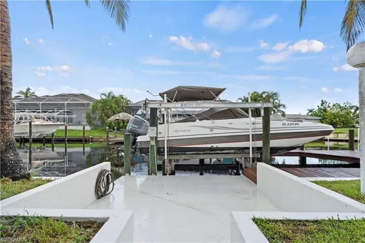 Dock with boat lift and a water view