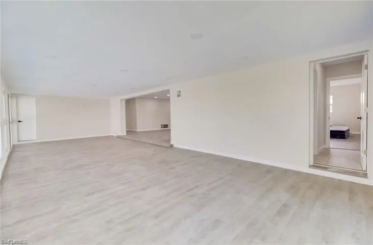 Spare room featuring light wood-type flooring and baseboards