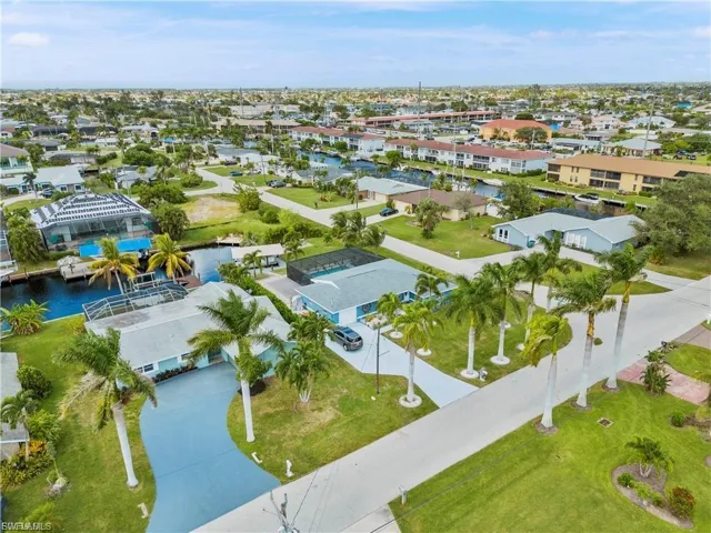 Aerial perspective of suburban area featuring a nearby body of water