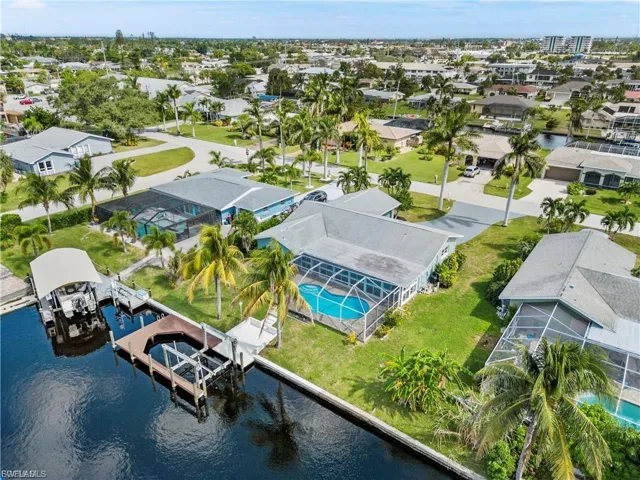 Bird's eye view of a nearby body of water and a pool