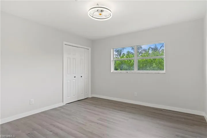 Unfurnished bedroom with light wood-style floors and a closet