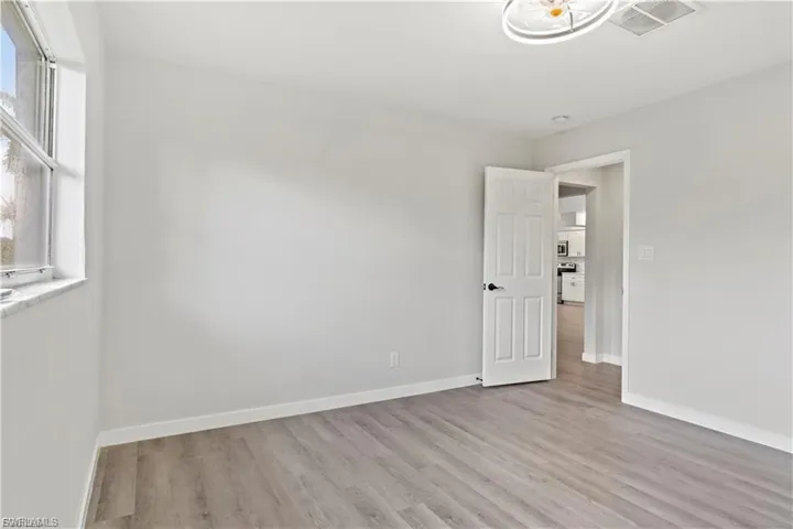 Empty room featuring light wood-type flooring and baseboards