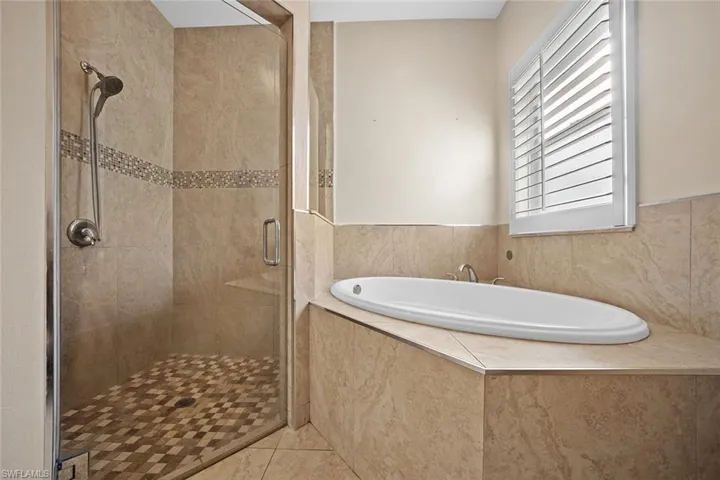 Full bathroom with a shower stall, a bath, and tile patterned floors