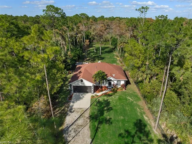 View from above of property with a forest