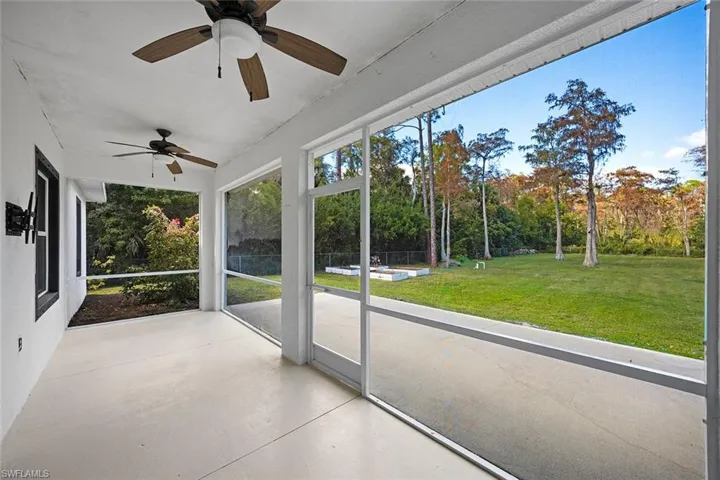 Unfurnished sunroom with a ceiling fan