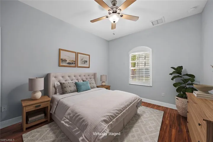 Bedroom with dark wood-style floors and ceiling fan