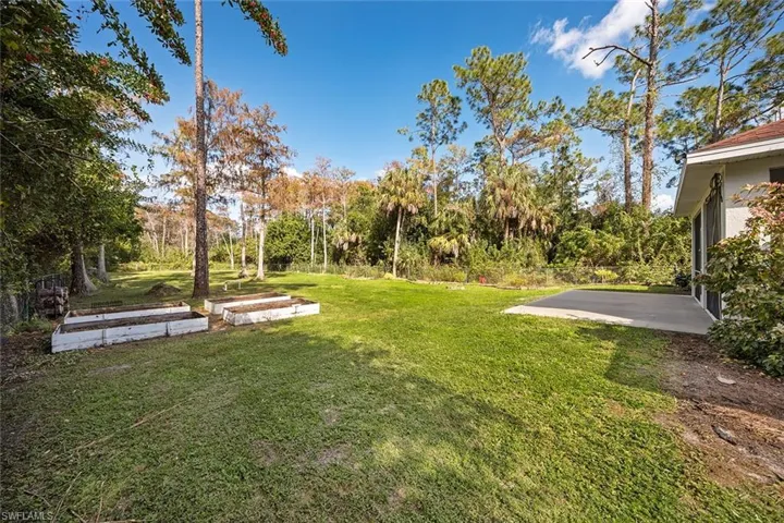 View of grassy yard with a garden