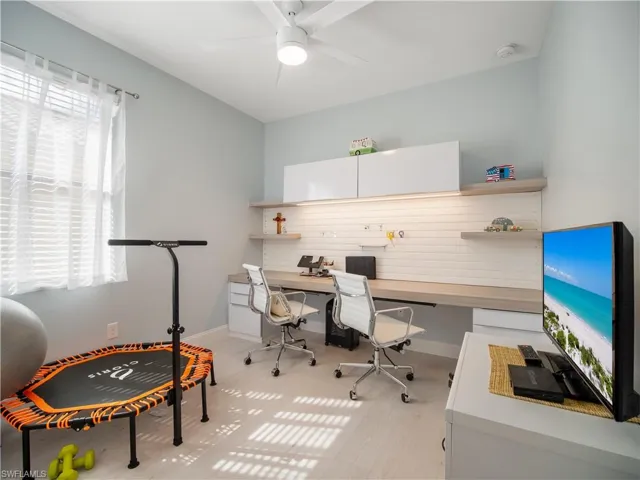 Office area with plenty of natural light and ceiling fan