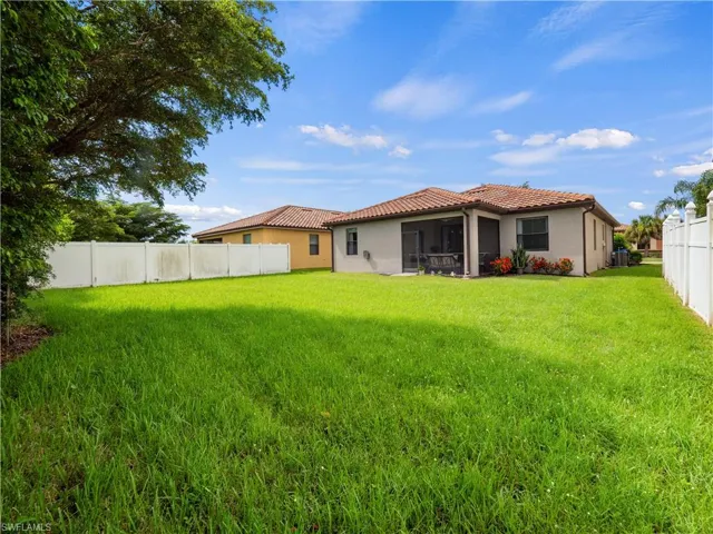 Rear view of house with a lawn