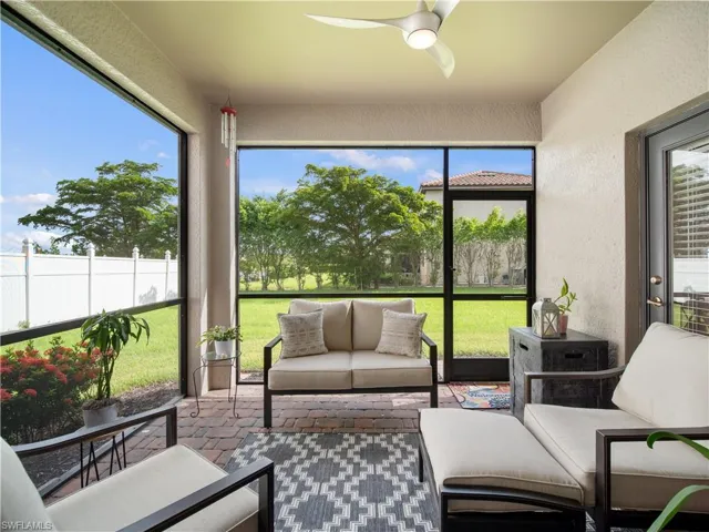 Sunroom / solarium with a wealth of natural light and ceiling fan