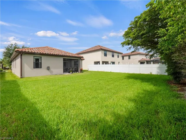 Back of house featuring a sunroom and a lawn