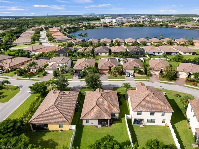Birds eye view of property with a water view