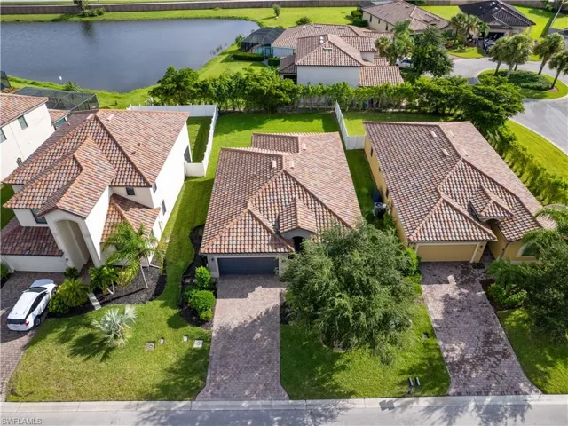Birds eye view of property with a water view