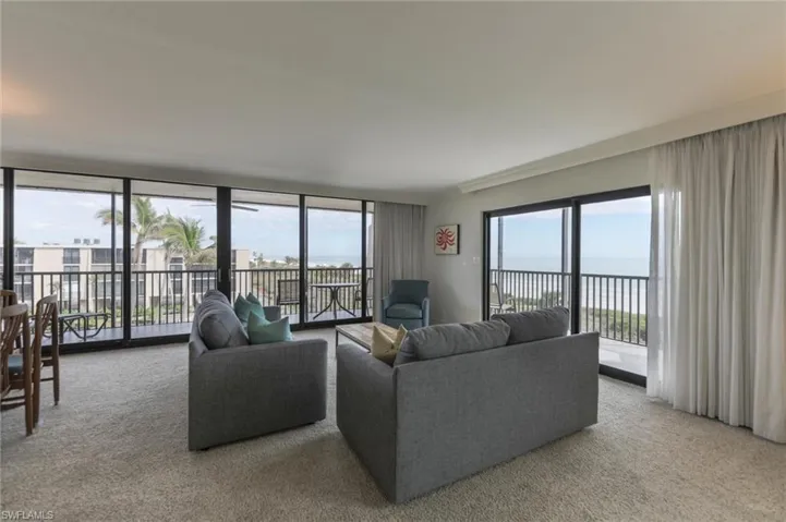 Carpeted living room with expansive windows