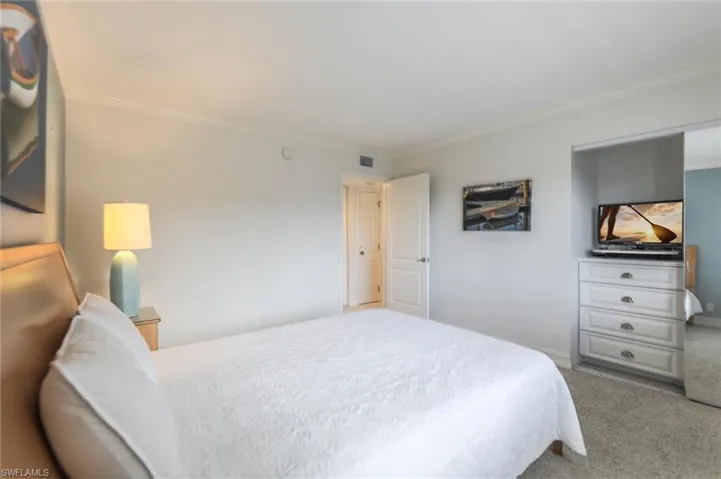 Bedroom featuring carpet and ornamental molding