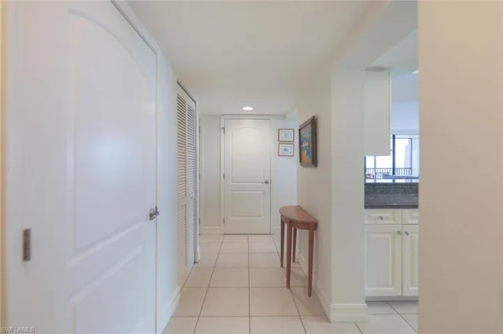 Hall featuring light tile patterned flooring