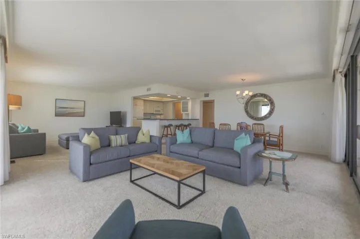 Carpeted living room featuring a chandelier