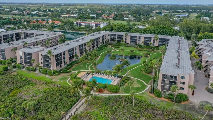 Birds eye view of property with a water view
