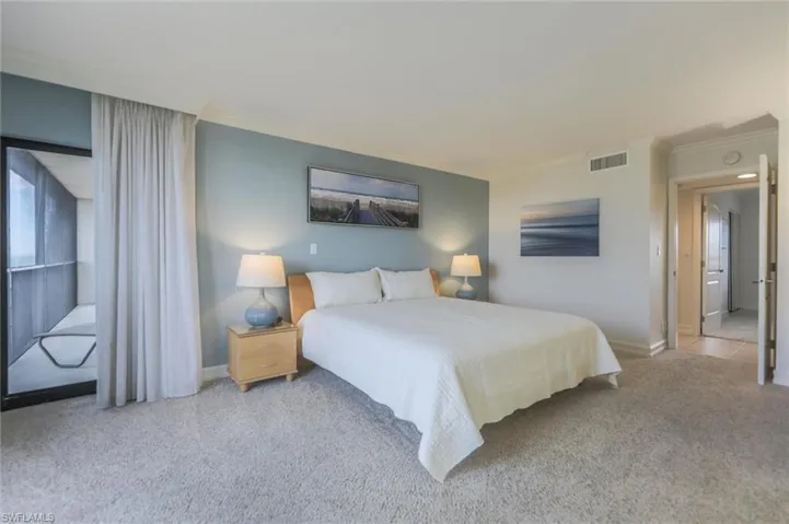 Carpeted bedroom with crown molding