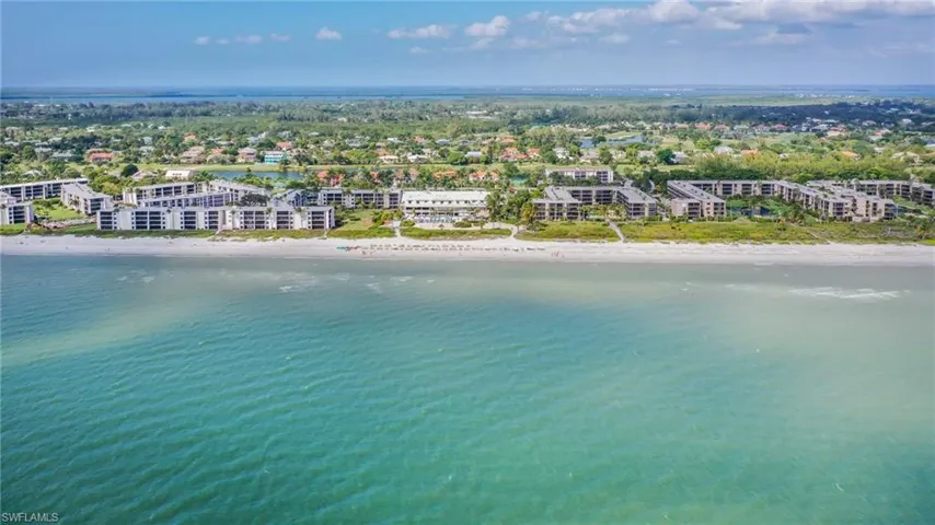 Drone / aerial view with a water view and a beach view