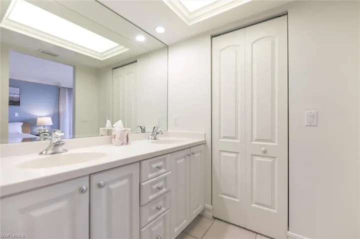 Bathroom with tile patterned floors and vanity
