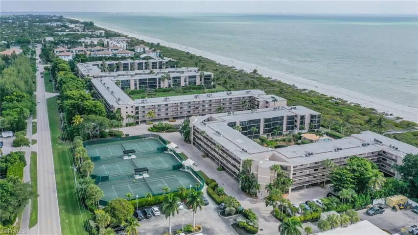 Birds eye view of property with a water view