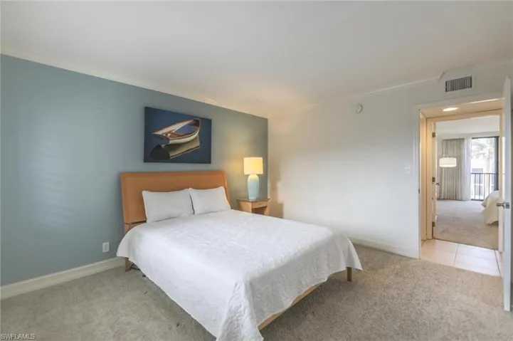 Carpeted bedroom with crown molding