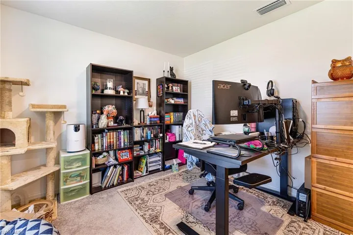 Carpeted home office featuDen/Flex Space/Home office with visible vents and carpetring visible vents