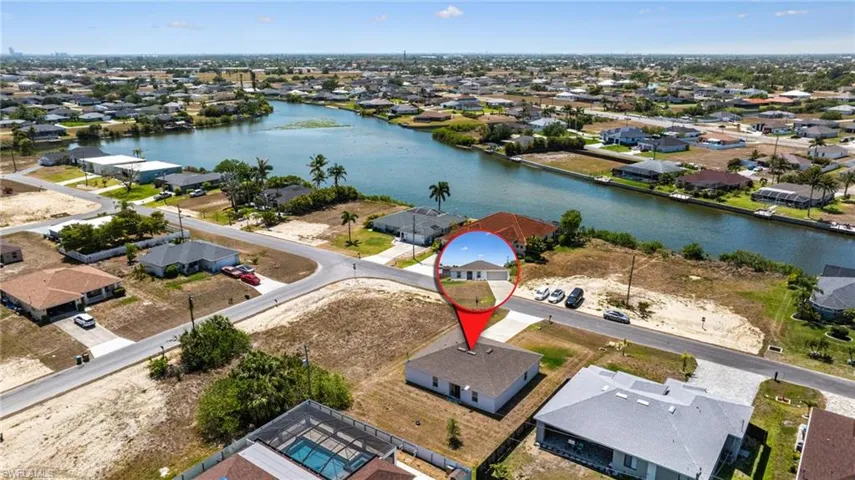 Drone / aerial view with a residential view and a water view