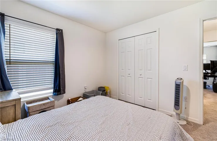 Guest bedroom - featuring baseboards and carpet floors