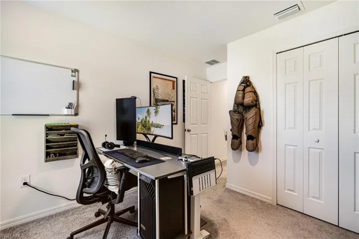 Guest bedroom - featuring baseboards and carpet floors