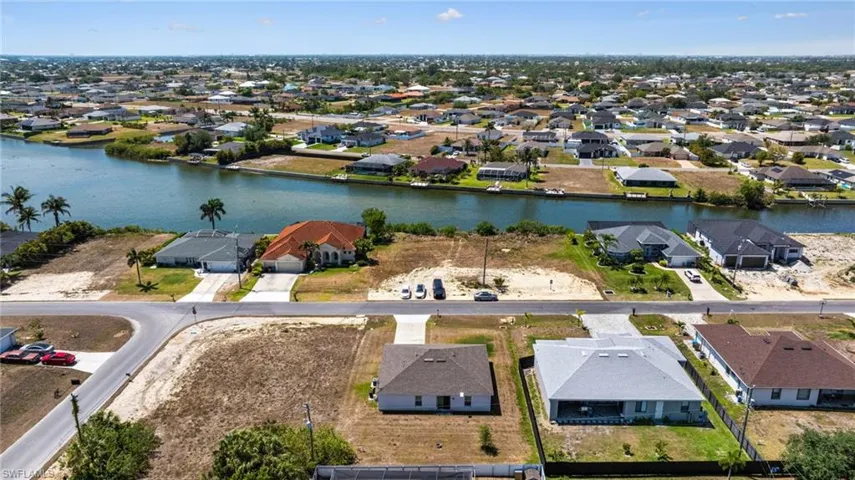 Aerial view featuring a residential view and a water view