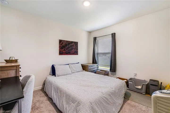 Guest bedroom - featuring baseboards and carpet floors