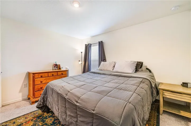 Primary Bedroom featuring carpet and baseboards